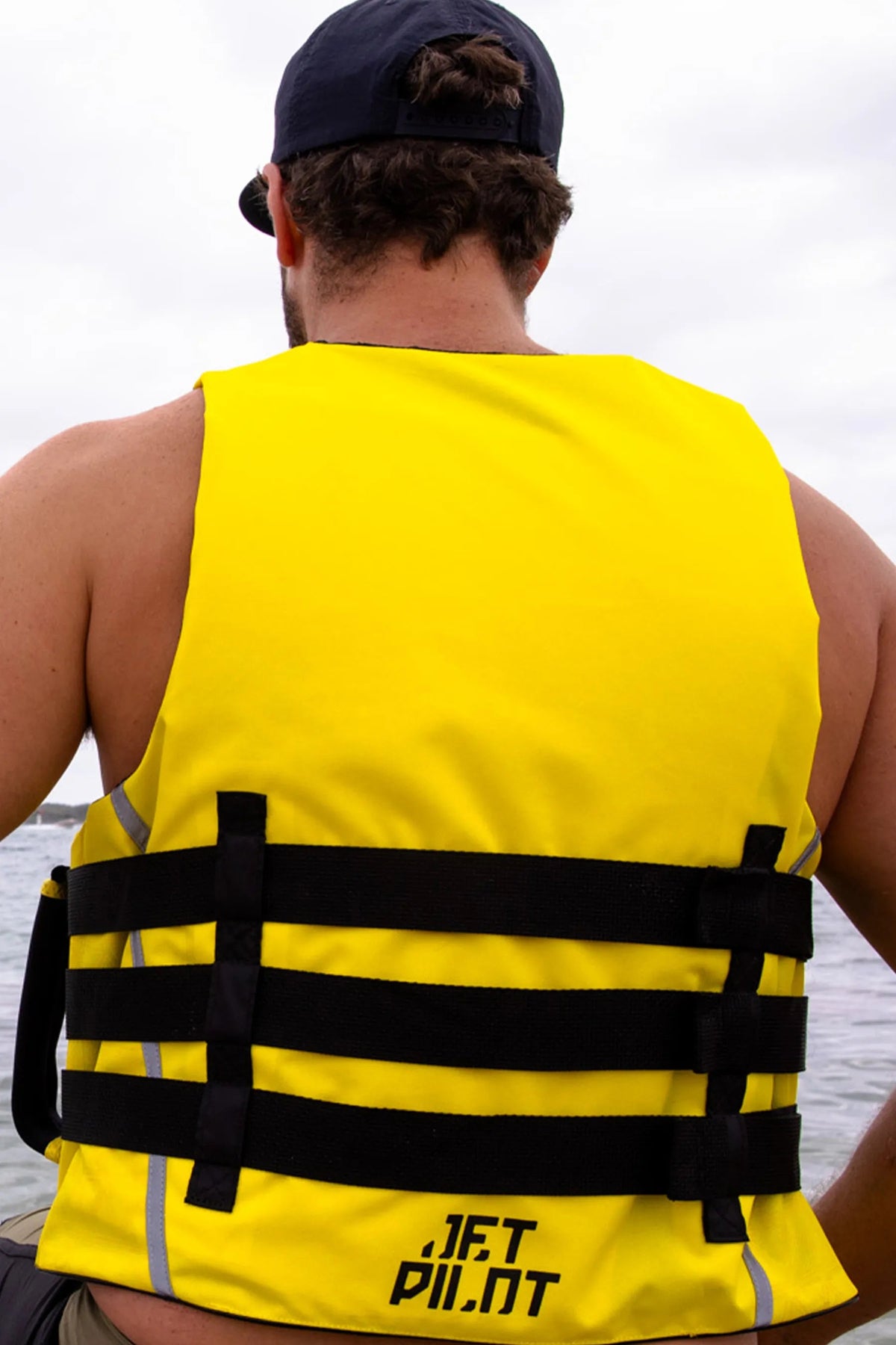Model seen from behind on the water in the Black/Yellow Titan Nylon, showing the back straps
